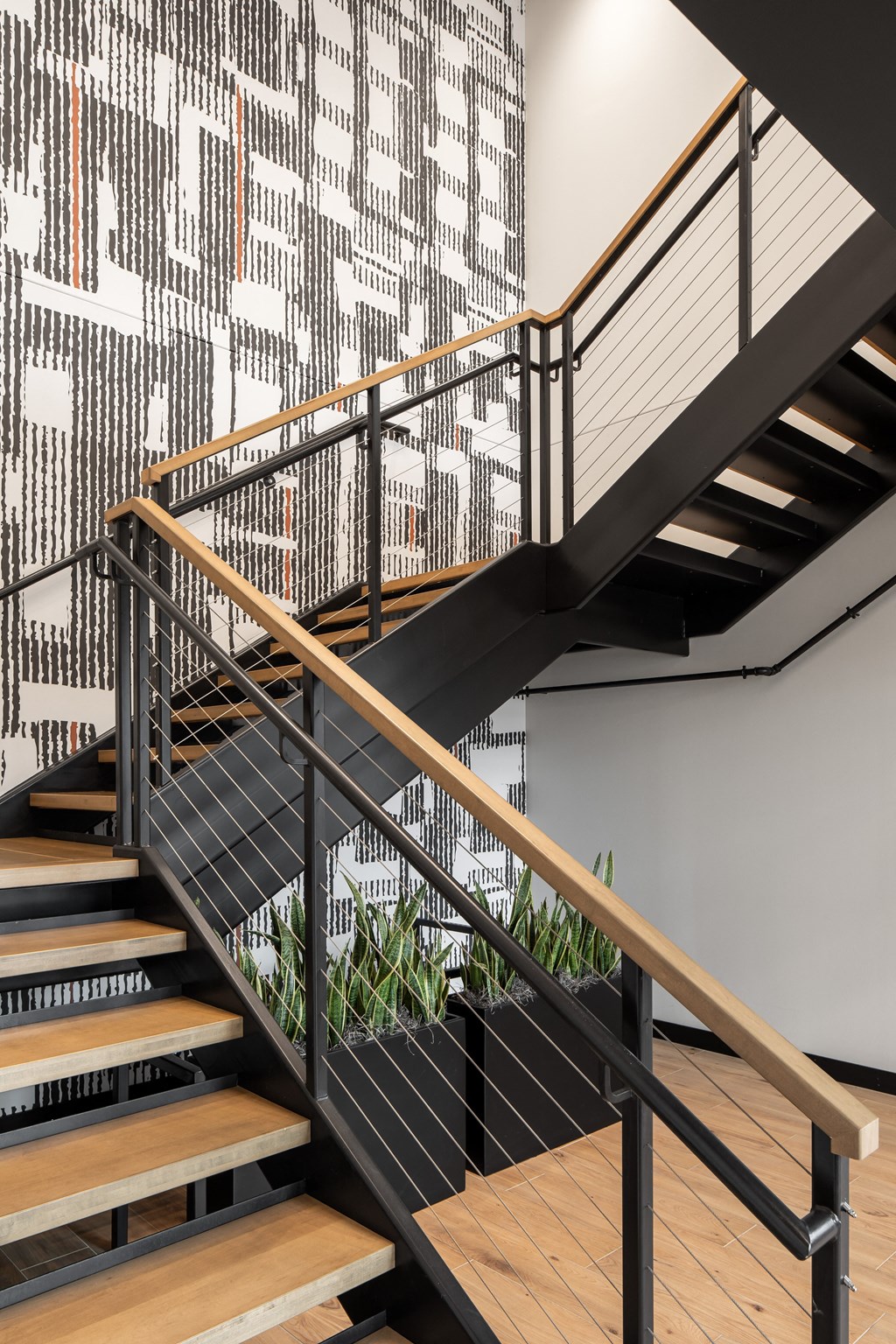 a metal staircase with wooden steps and a wall covered in graffiti