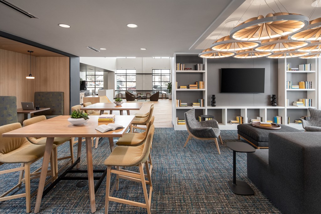 a large room with a table and chairs and a television