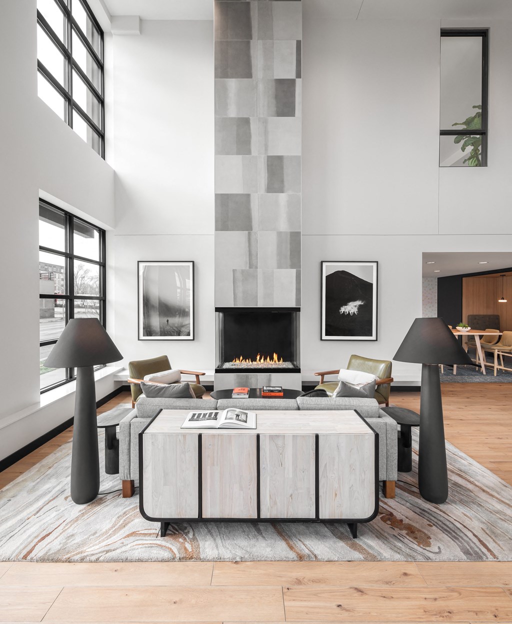 a living room with a large table and a fireplace