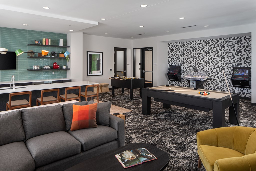a living room with a billiards table and a pool table