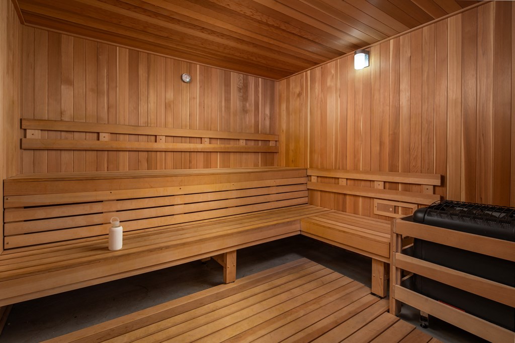 a sauna with wooden benches and a candle