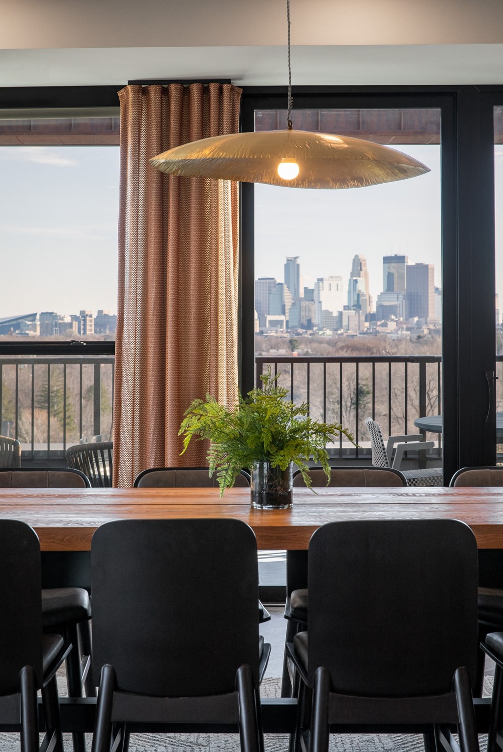 a dining room with a table and chairs and a view of the city