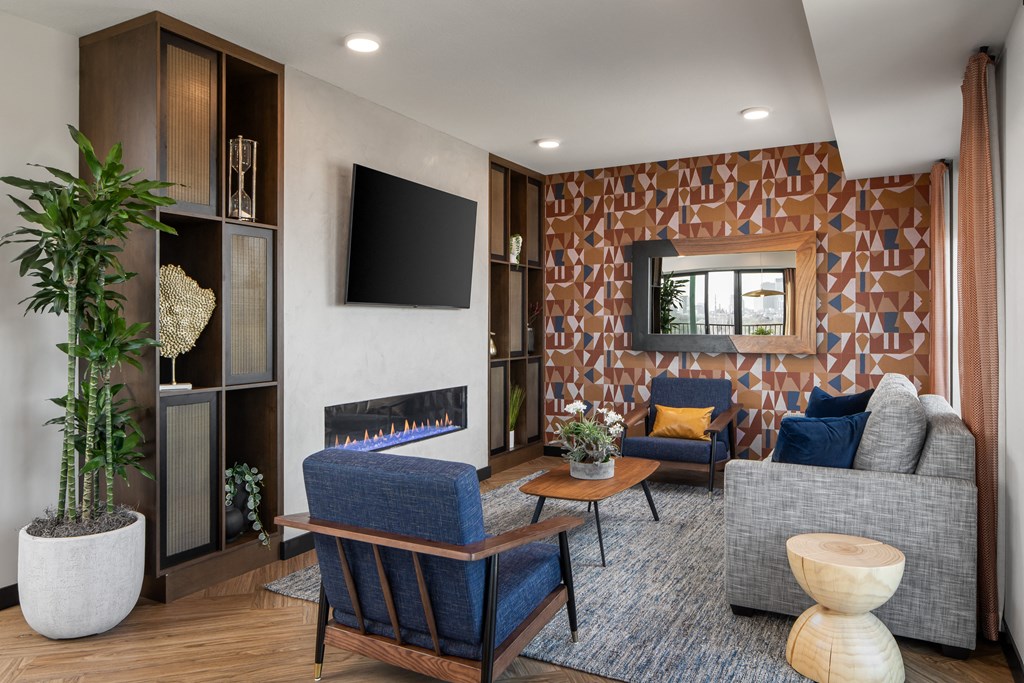 a living room with a gray couch and a fireplace
