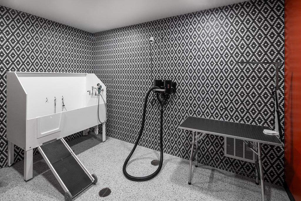 a bathroom with a shower and a sink and a table