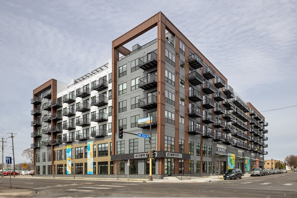a large apartment building on the corner of a city street
