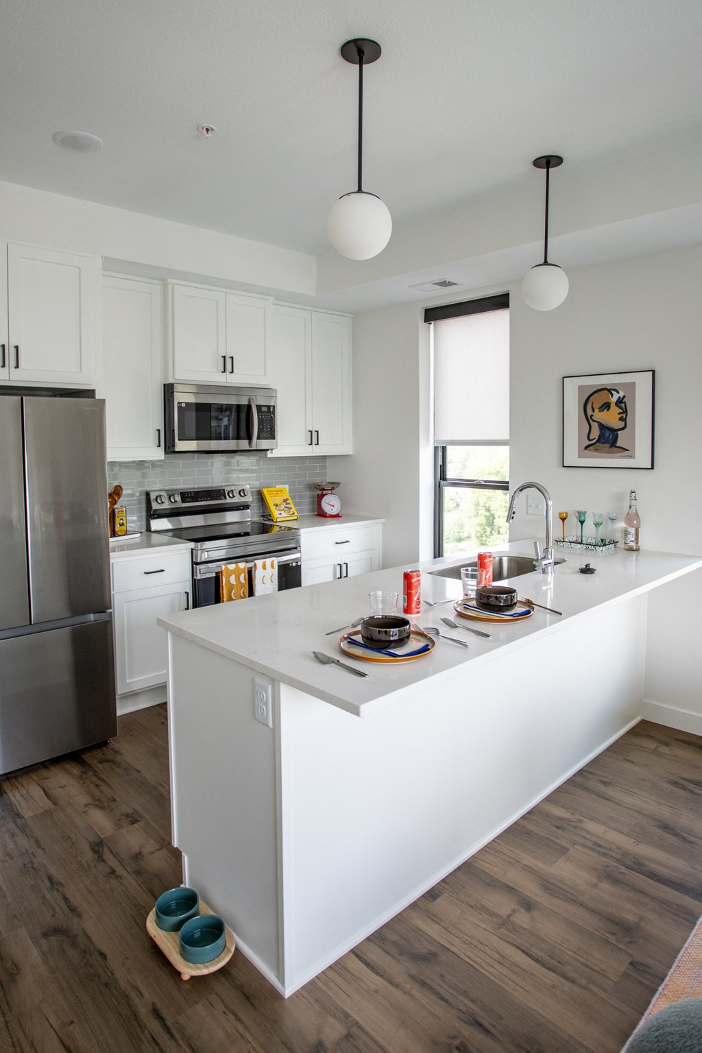 a kitchen with white cabinets and a large white island