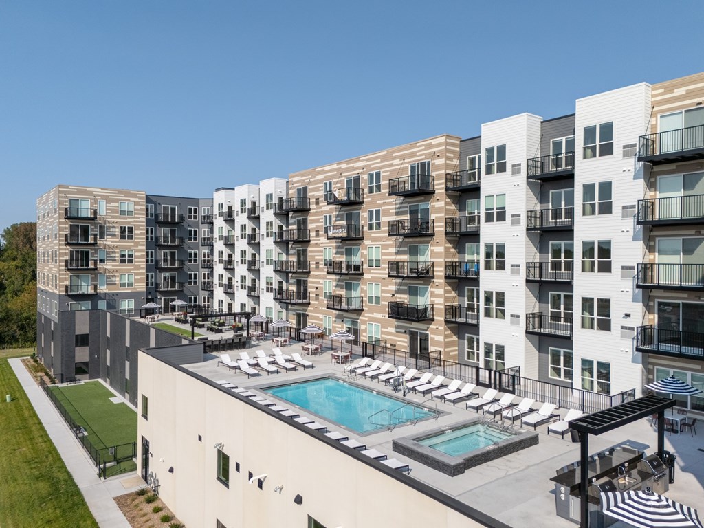 A large apartment complex with a pool and a patio area.