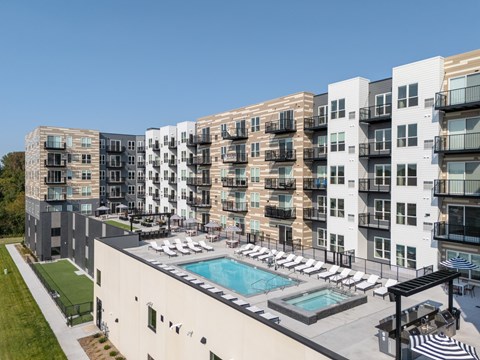 A large apartment complex with a pool and a patio area.