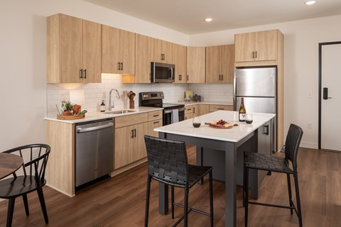 A modern kitchen with a table and chairs.