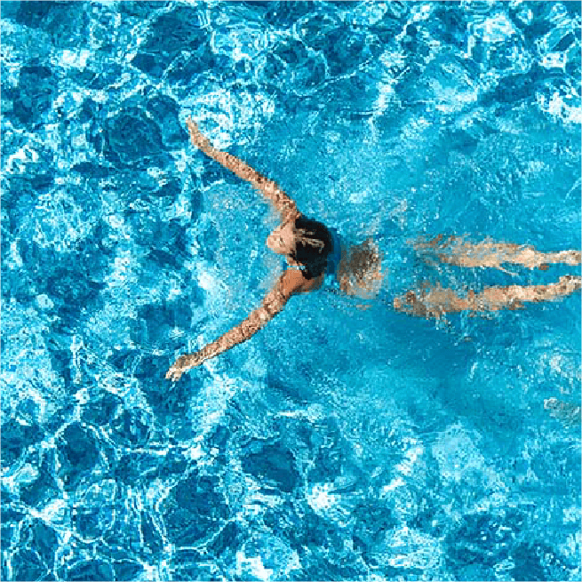 a woman swimming in a pool