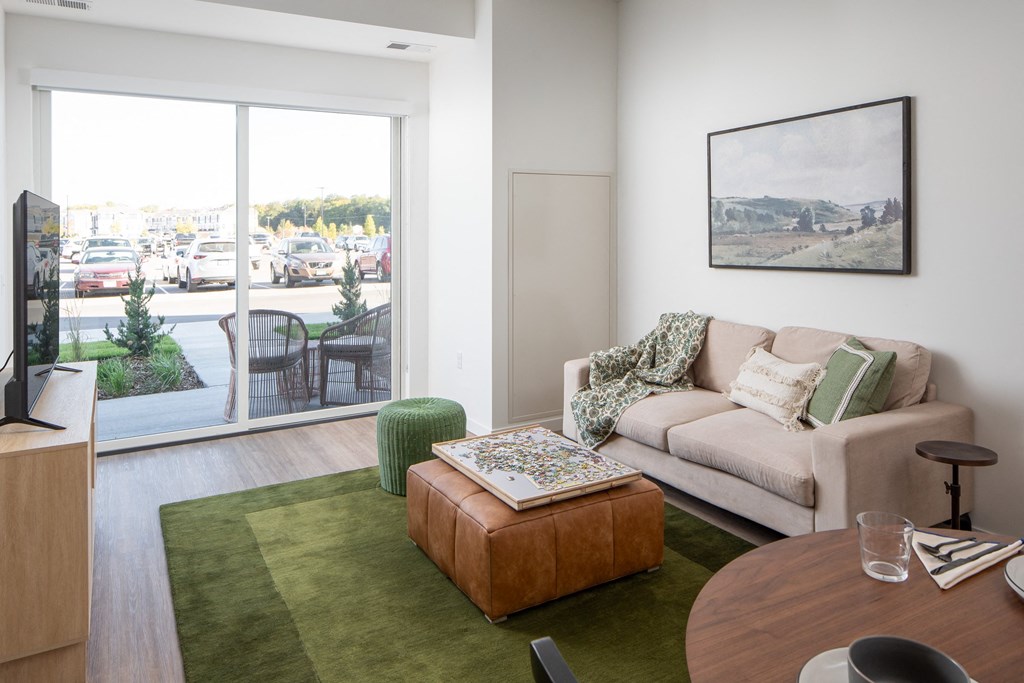 a living room with a couch and a table     and a patio