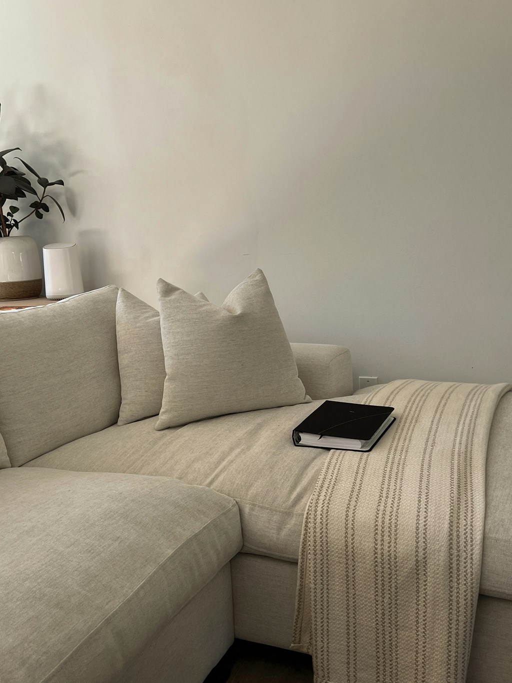 a tablet sitting on a couch in a living room