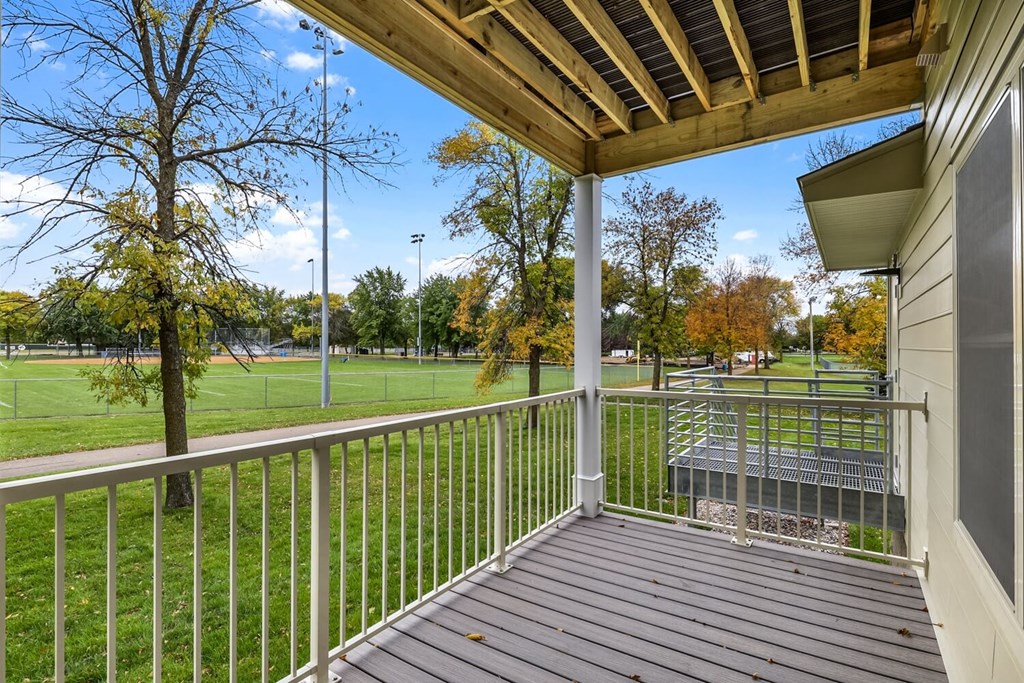 the view from the deck of a house overlooking a park