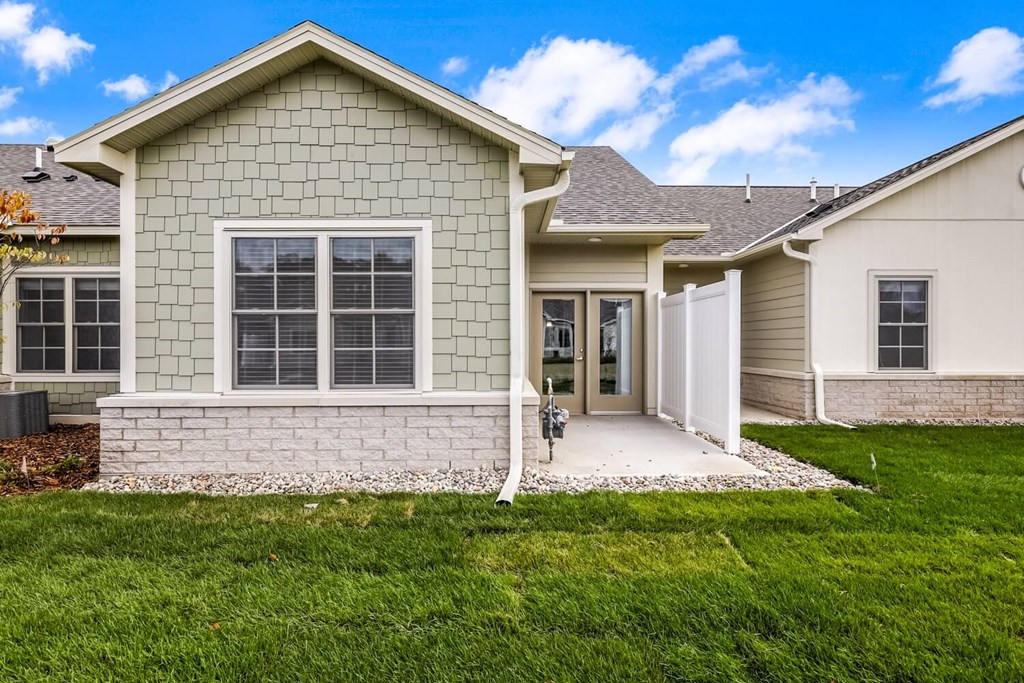 a house with a driveway and a lawn