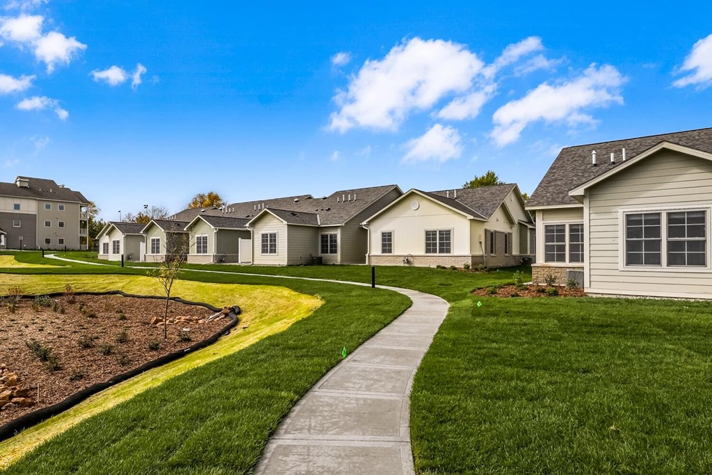 a sidewalk leading to a row of houses