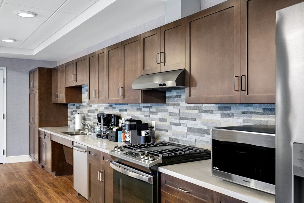 a kitchen with stainless steel appliances and wooden cabinets