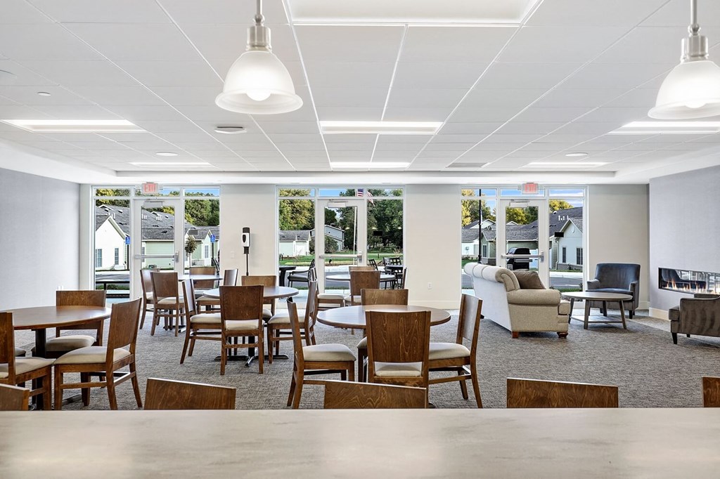 the lobby of a building with tables and chairs