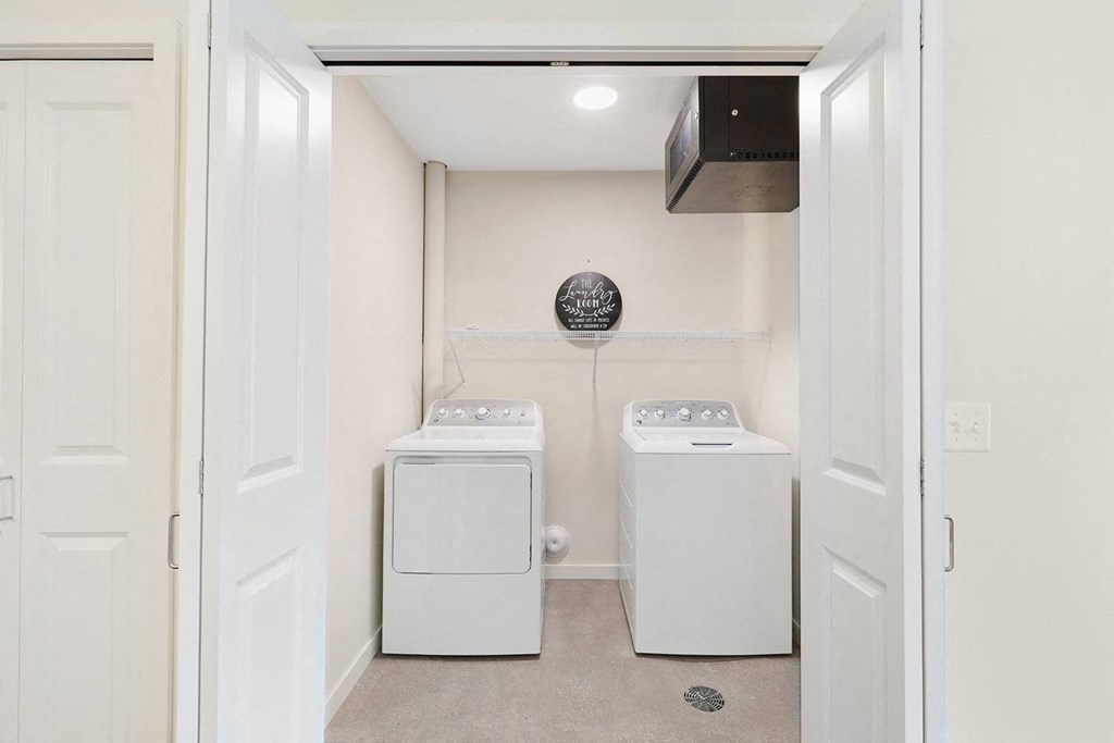a white laundry room with a washer and dryer in it