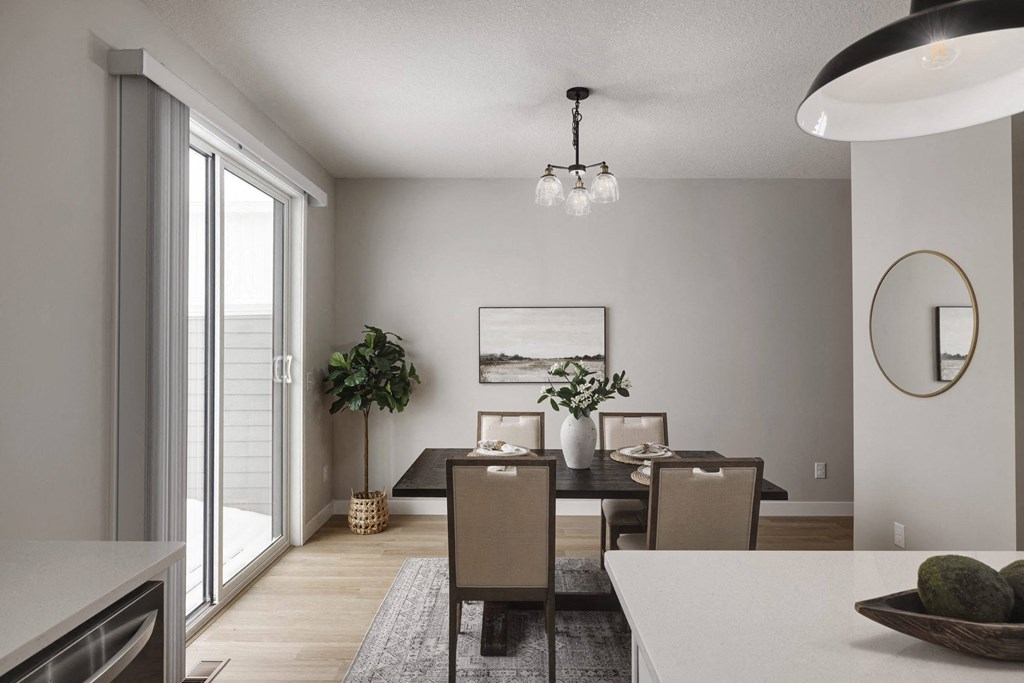 A modern dining room with a large table and chairs.