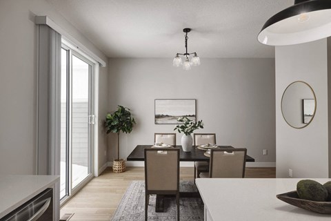 A modern dining room with a large table and chairs.