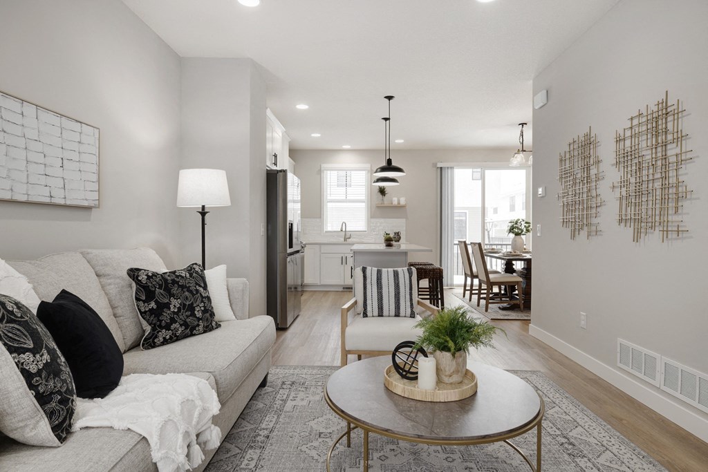 A living room with a couch, coffee table, and a large painting on the wall.