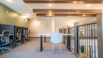 A conference room with a white table and chairs.