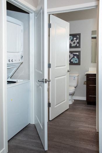 A white door is open to a bathroom.