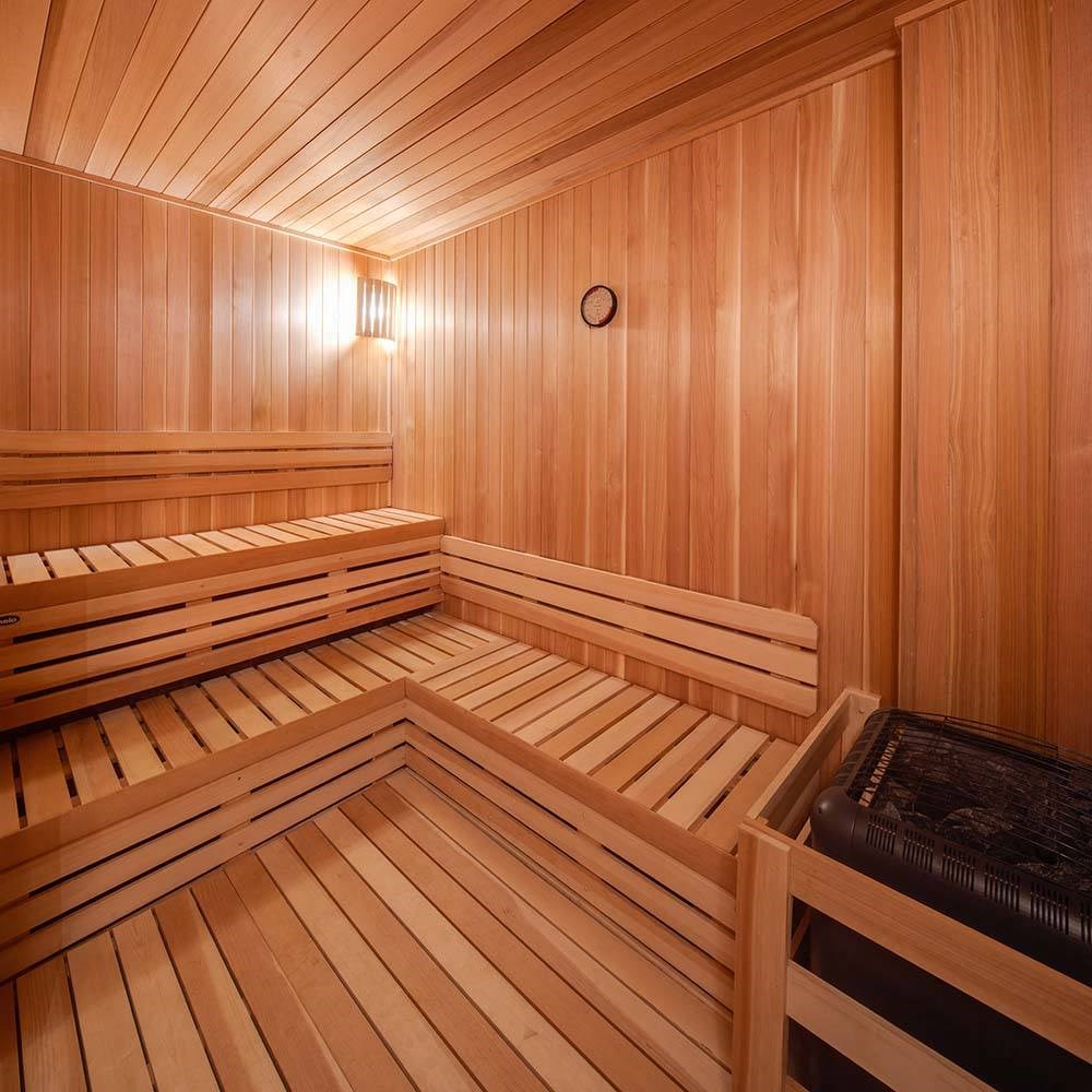 a sauna in a wooden room with wooden walls and benches
