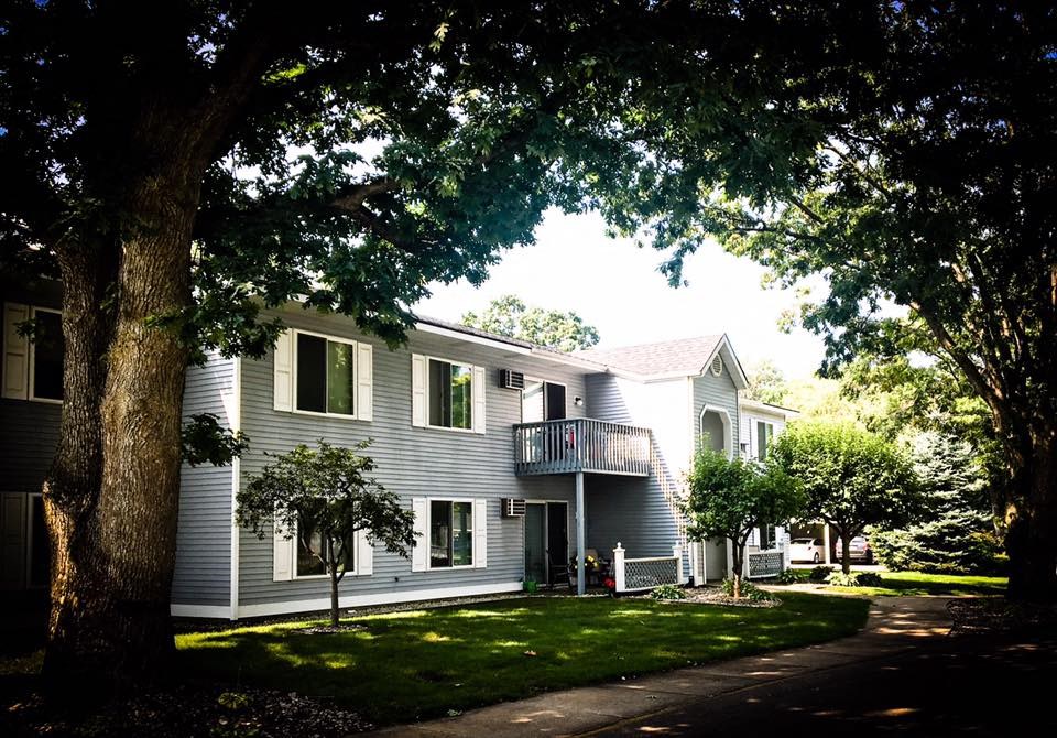 a white house with trees in front of it