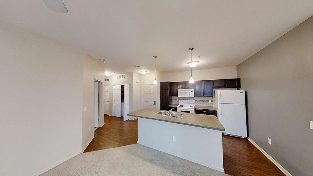 the interior of a room with white walls and wooden floors
