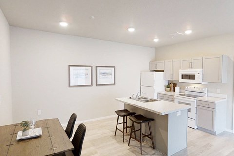 A kitchen with a dining table and chairs.