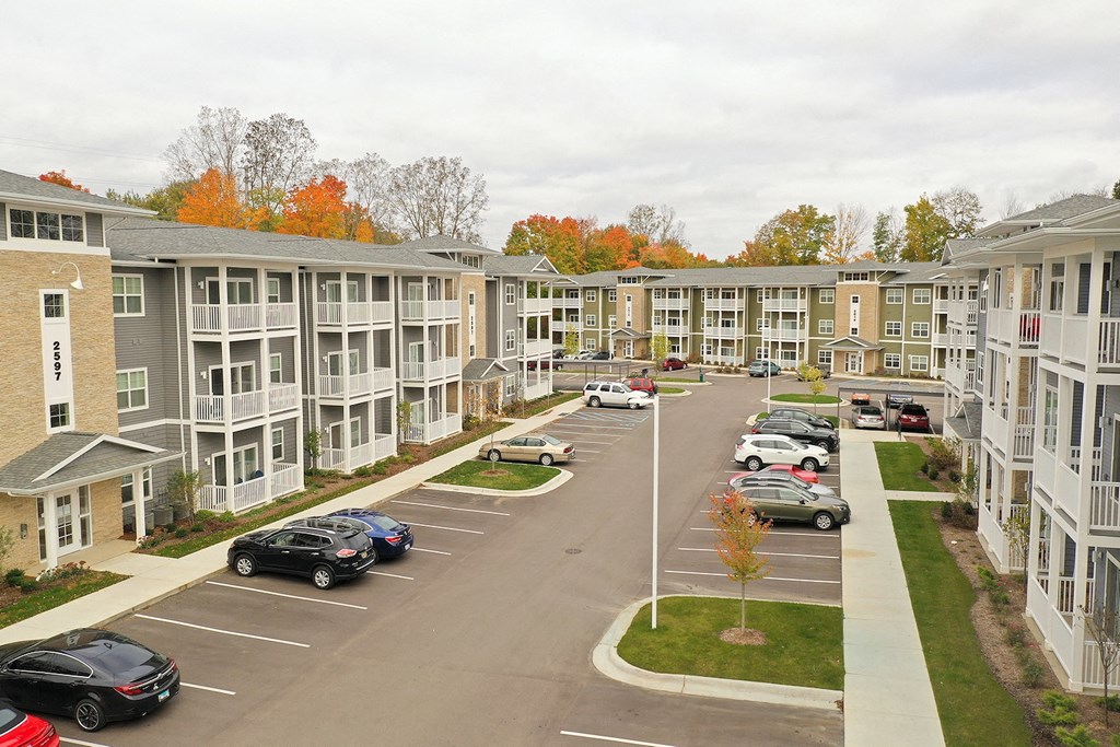 a view of a parking lot in front of an apartment complex