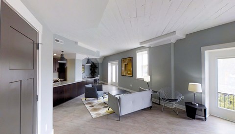 the living room is open to the kitchen and dining room