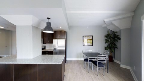 a kitchen and dining room with a table and chairs