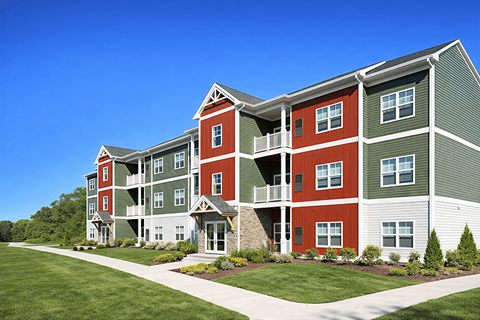 A large red and green building with a clear blue sky in the background.