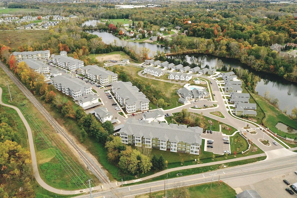 an aerial view of a city with a river and buildings
