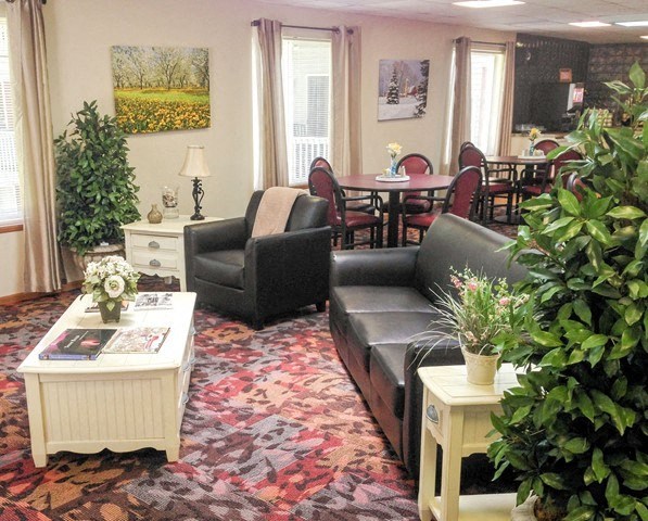 a living room with a couch and chairs and a table