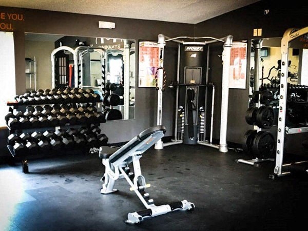 a gym with weights and other equipment in it