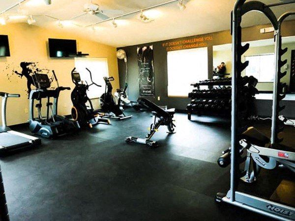 a gym with a bunch of exercise equipment in it