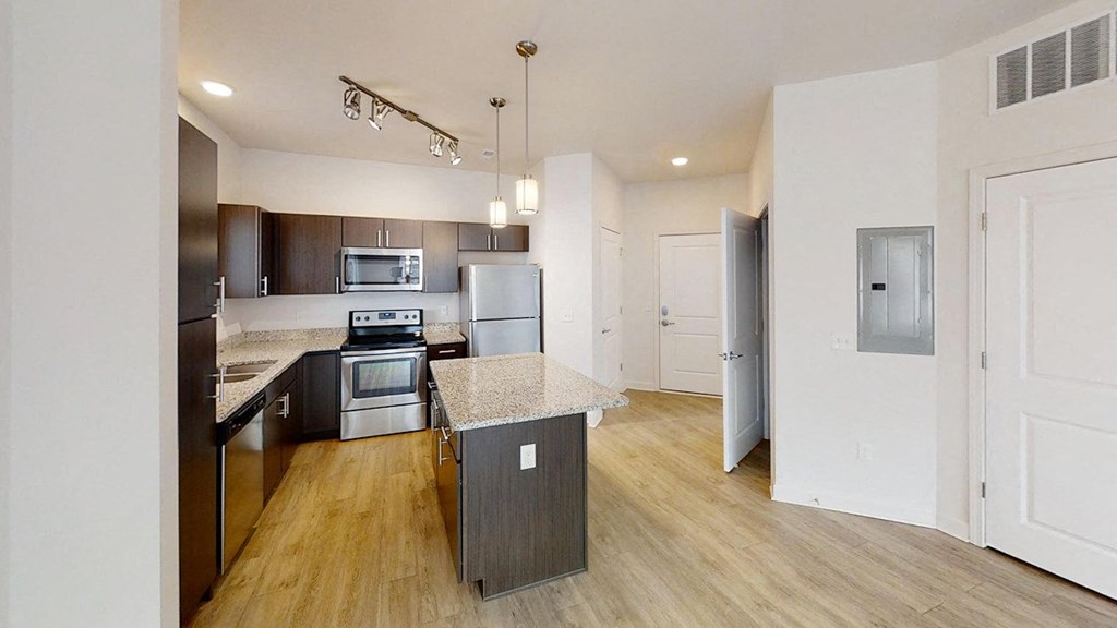 a kitchen with an island and stainless steel appliances