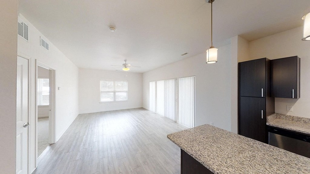 the spacious living room and dining room of an apartment