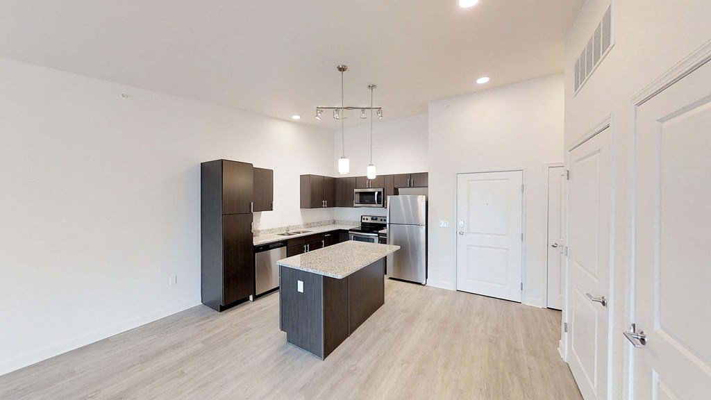 a renovated kitchen with a island and stainless steel appliances
