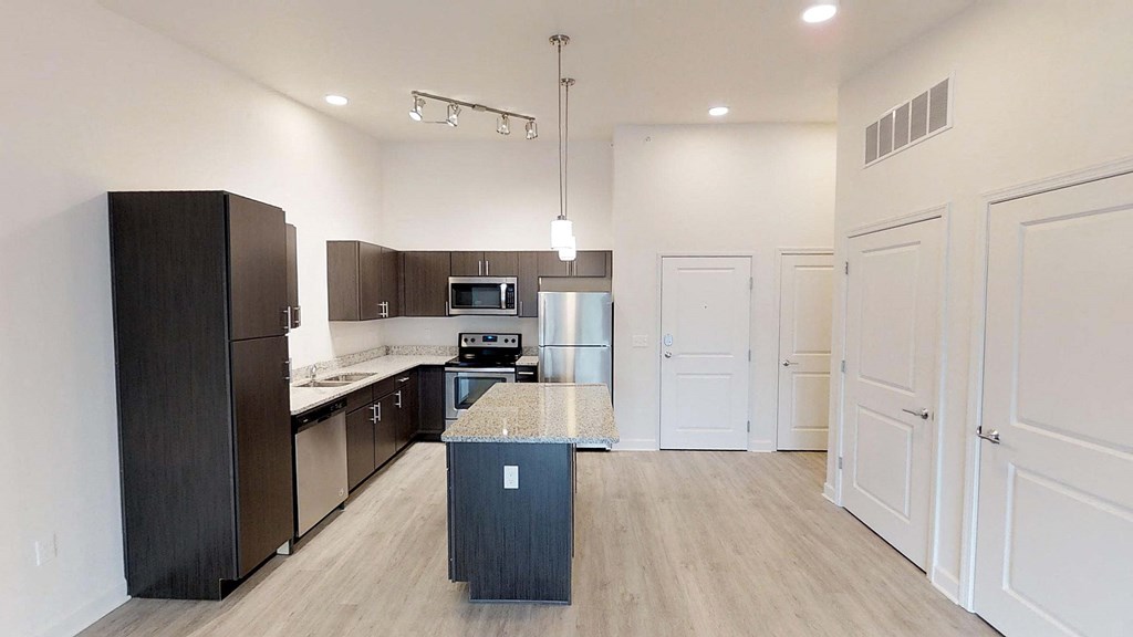 a kitchen with stainless steel appliances and a counter top