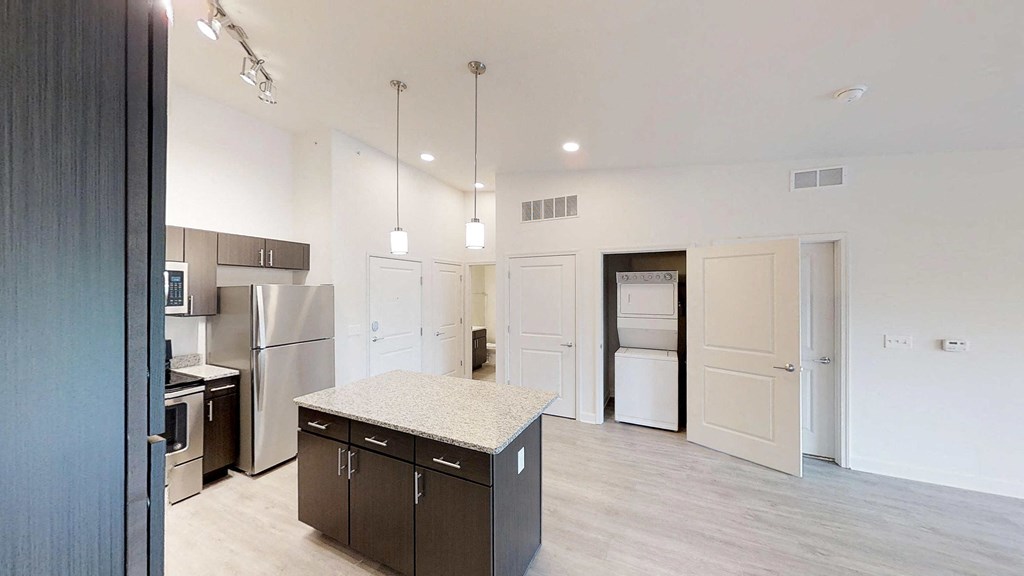a kitchen with stainless steel appliances and a granite counter top