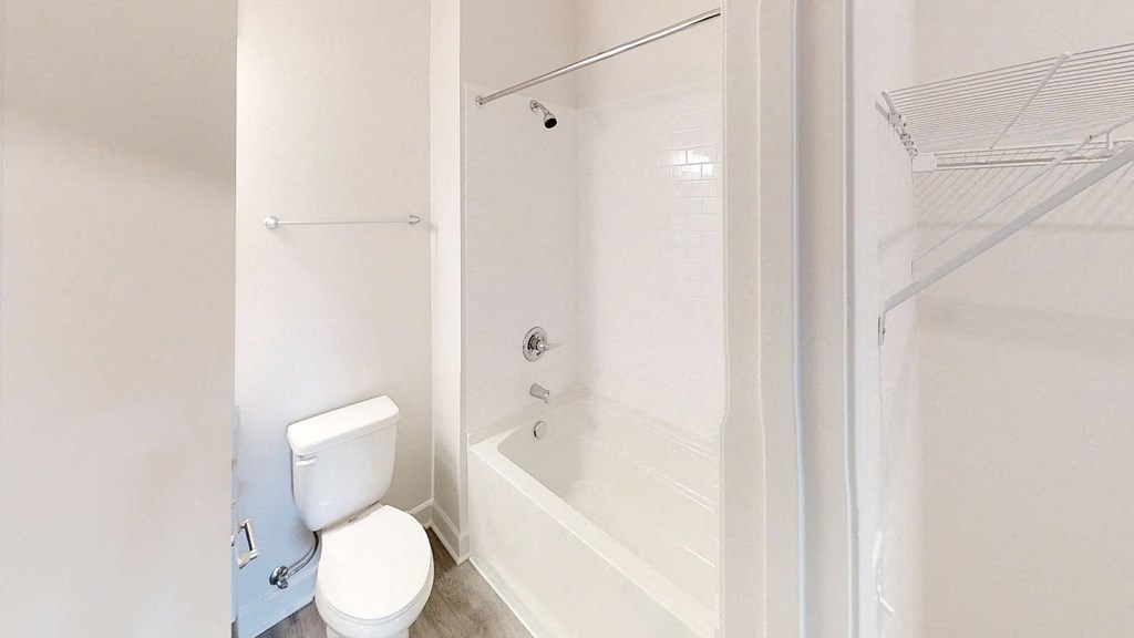 a bathroom with a toilet and a tub