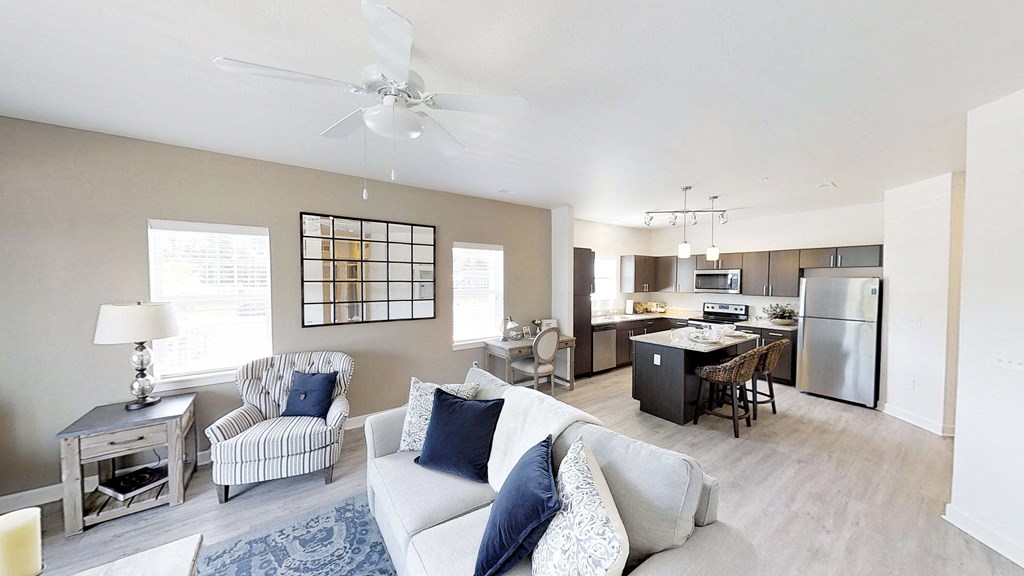 a living room with a couch and a kitchen
