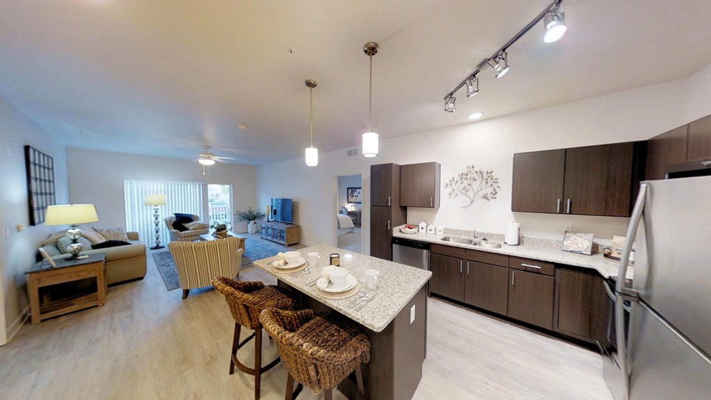 a kitchen and living room with a table and chairs