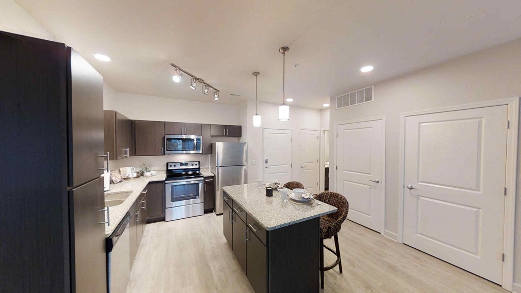 a kitchen with stainless steel appliances and a counter top