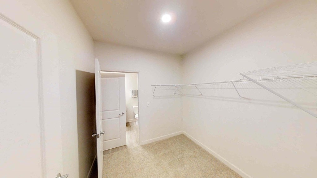 a room with a closet and a door to a bathroom