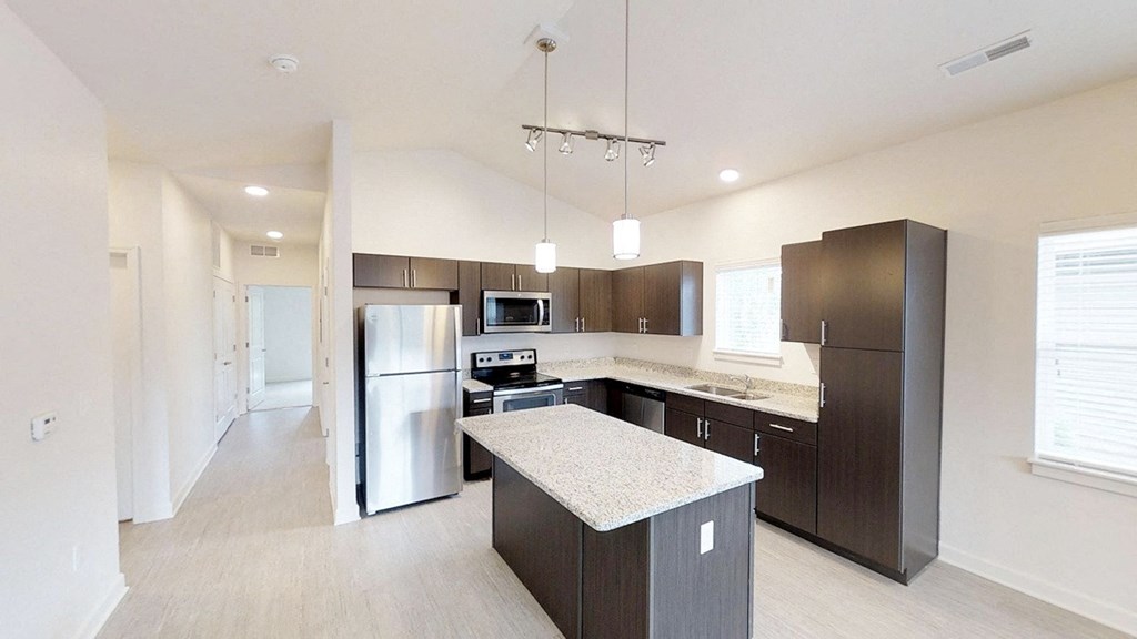 a kitchen with stainless steel appliances and a marble counter top